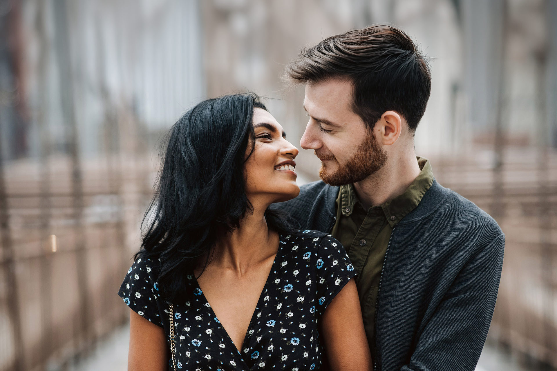 Couple embracing on a city bridge, representing relationship and intimacy therapy.